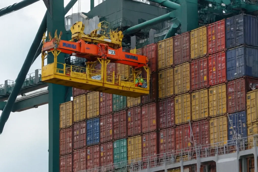 Container ship being loaded at a global shipping port with a Bromma crane, illustrating international freight operations for the Top 10 Logistics Companies in the World 2025.